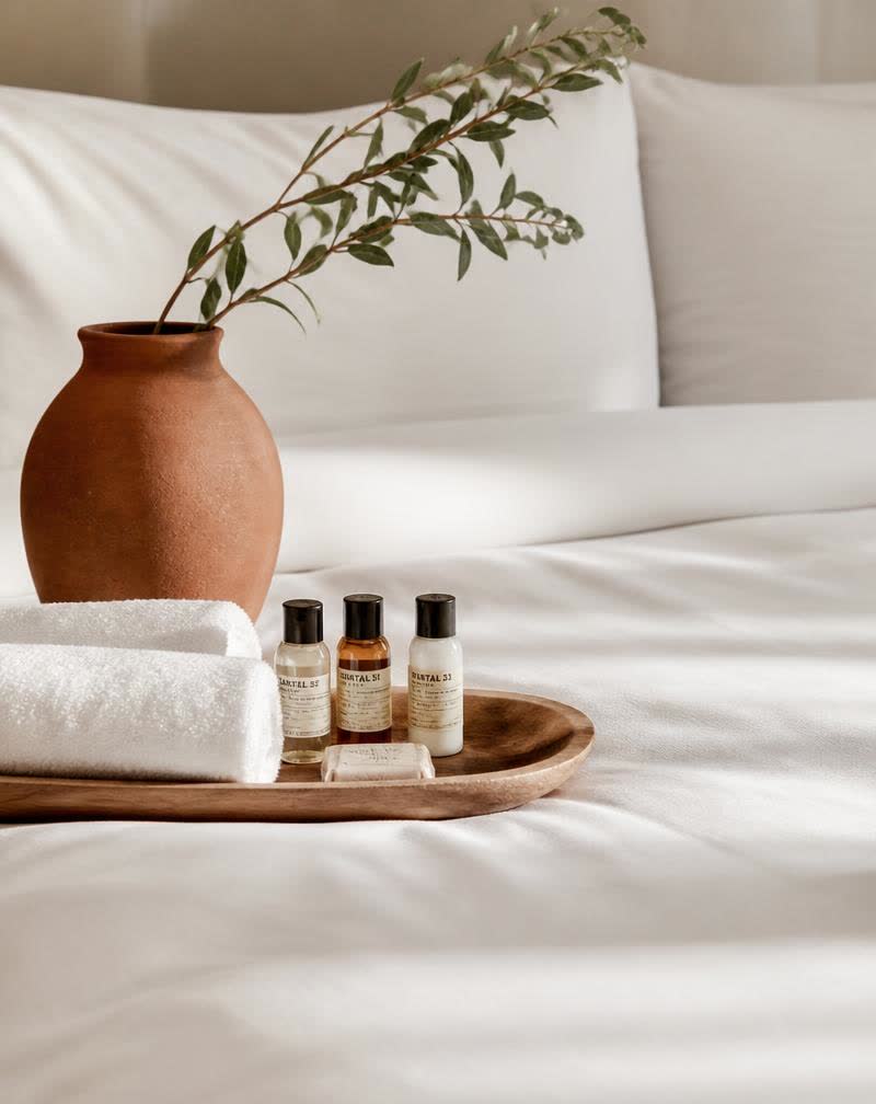 Close-up of crisp white hotel linens and luxury amenities